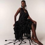 fibyus black ruffle midi dress model seated